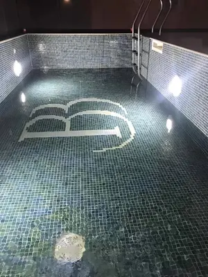 a bathroom with a tiled floor with the number at Datek's Apartments in Ulcinj
