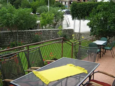a table and chairs with a yellow napkin on it at Rooms & Apartments Vukasović in Kotor