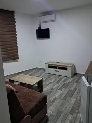 a living room with a couch and a table at Apartmani Bosfor in Dobra Voda