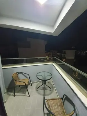 two chairs and a table on top of a balcony at Apartmani Bosfor in Dobra Voda