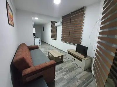 a living room with a couch and a tv at Apartmani Bosfor in Dobra Voda