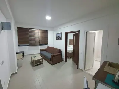 a living room with a couch and a table at Apartmani Bosfor in Dobra Voda