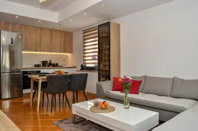 a living room with a couch and a table at Moderan dvosoban stan in Budva