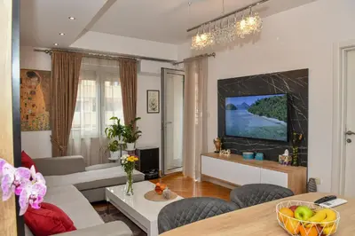 a living room with a couch and a table at Moderan dvosoban stan in Budva