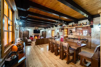 a kitchen and living room with a table and chairs at Handmade house Rijeka Crnojevica in Donje Selo