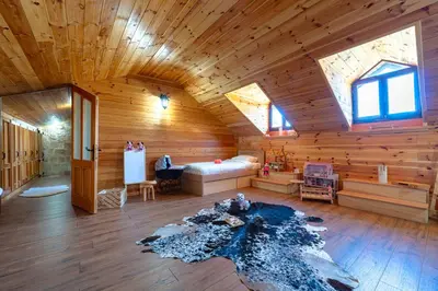 a room with a bed in a wooden cabin at Handmade house Rijeka Crnojevica in Donje Selo
