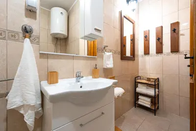 a bathroom with a white sink and a mirror at Handmade house Rijeka Crnojevica in Donje Selo