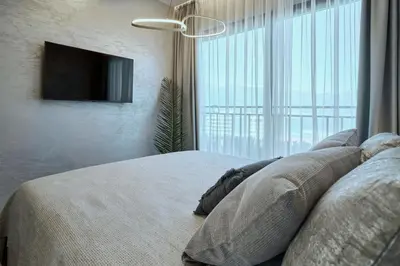 a bedroom with a bed with a television on a wall at Apartments Alacritas in Budva