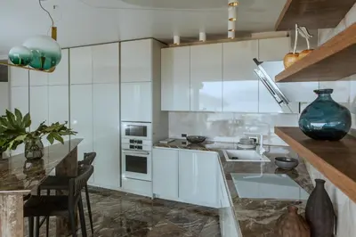 a kitchen with white cabinets and a counter top at Apartments Alacritas in Budva