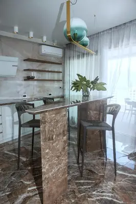 a kitchen with a large stone counter and chairs at Apartments Alacritas in Budva