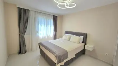 a bedroom with a bed and a large window at Luxury Suite in Kotor