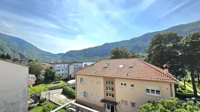 a view of a house with mountains in the background at Luxury Suite in Kotor