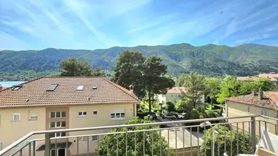 a view from the balcony of a house with mountains in the background at Luxury Suite in Kotor