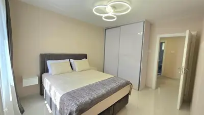 a bedroom with a bed and a ceiling fan at Luxury Suite in Kotor