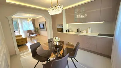 a kitchen and dining room with a glass table and chairs at Luxury Suite in Kotor