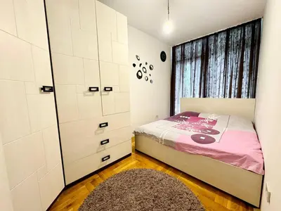 a small bedroom with a bed and a window at Şehir merkezi manzaralı modern in Podgorica