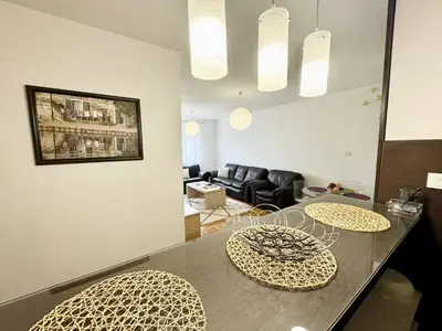 a living room with a table and two chairs at Şehir merkezi manzaralı modern in Podgorica
