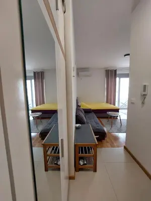 a room with rows of beds and a mirror at TiN Apartment in Ulcinj