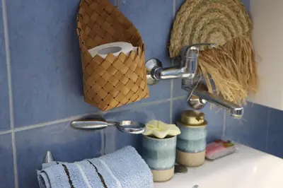 a bathroom sink with a towel and a faucet at Pampas Family Apartment in Dobrota