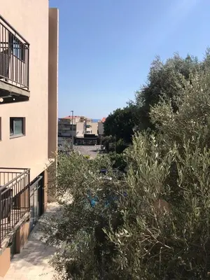 a balcony of a building with bushes and trees at Apartment Relax Petrovac in Petrovac na Moru