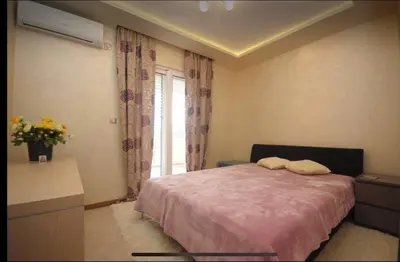 a bedroom with a bed and a window at Apartment Relax Petrovac in Petrovac na Moru