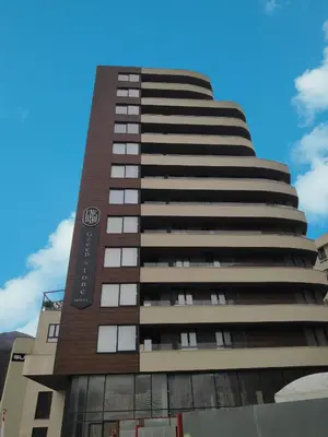 a tall building with a sign on it at Apartmani Đurović in Becici