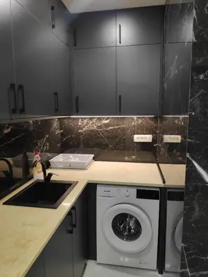 a kitchen with a washing machine and a sink at Apartmani Đurović in Becici