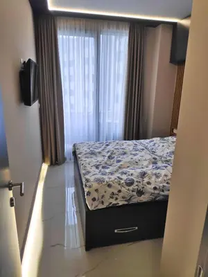 a bedroom with a bed and a window at Apartmani Đurović in Becici