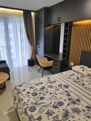 a hotel room with a bed and a desk at Apartmani Đurović in Becici
