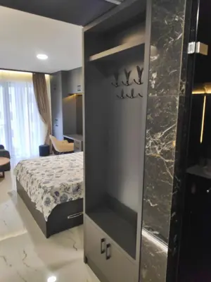 a bedroom with a bed and a large mirror at Apartmani Đurović in Becici