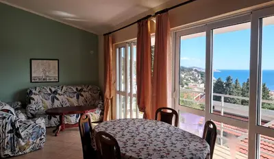 a room with a table and a chair and a window at Мрія in Sutomore