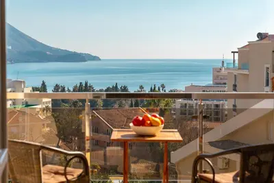 a bowl of fruit on a table on a balcony at Katarina17 in Becici