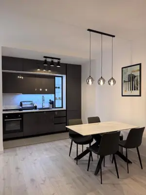 a kitchen and dining room with a table and chairs at Ponte Nuovo De Luxe Apartment in Ulcinj