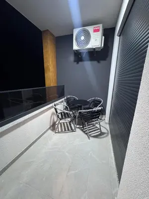 a dining room with a table and chairs and a fan at Ponte Nuovo De Luxe Apartment in Ulcinj
