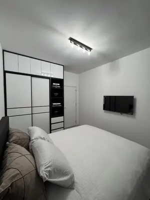 a bedroom with a bed and a flat screen tv at Ponte Nuovo De Luxe Apartment in Ulcinj