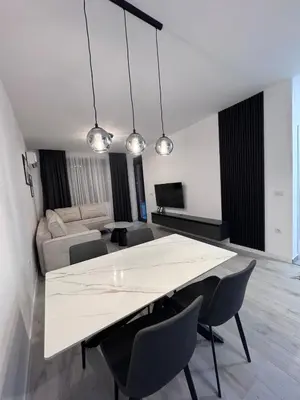 a living room with a large white table and chairs at Ponte Nuovo De Luxe Apartment in Ulcinj