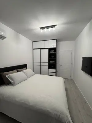 a white bedroom with a large white bed in it at Ponte Nuovo De Luxe Apartment in Ulcinj