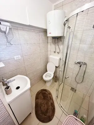 a bathroom with a toilet and a sink and a shower at Zinzula 3 in Bar, Susanj