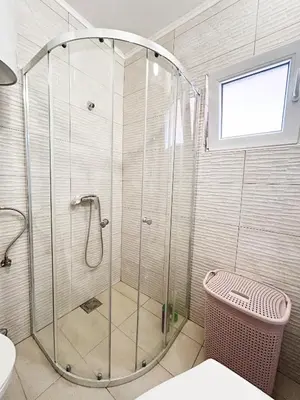 a shower with a glass door in a bathroom at Zinzula 3 in Bar, Susanj