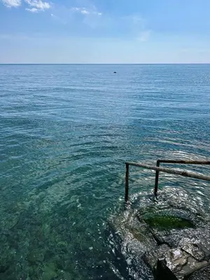 a view of the ocean with a railing in the water at Zinzula 3 in Bar, Susanj