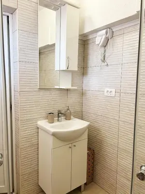 a bathroom with a sink and a mirror at Zinzula 3 in Bar, Susanj