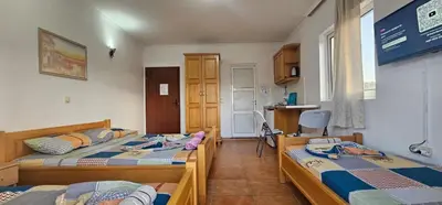 a room with two beds and a kitchen at OliveGarten Apartments in Ulcinj