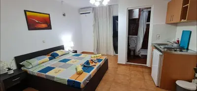 a small bedroom with a bed in a kitchen at OliveGarten Apartments in Ulcinj