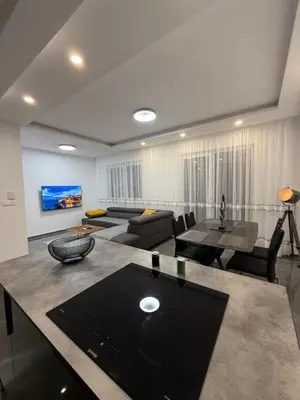 a living room with a couch and a table at Skyline View Apartment in Ulcinj