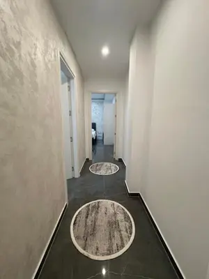a hallway with two rugs on the floor at Skyline View Apartment in Ulcinj