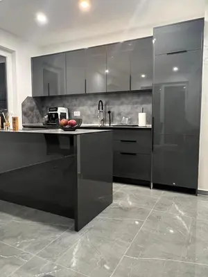 a kitchen with black cabinets and a counter top at Skyline View Apartment in Ulcinj