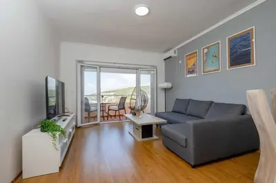 a living room with a couch and a tv at Azzurro Apartment in Utjeha in Utjeha