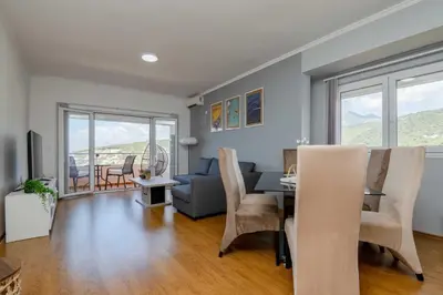 a living room with a table and a couch at Azzurro Apartment in Utjeha in Utjeha