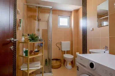 a bathroom with a shower and a toilet and a sink at Azzurro Apartment in Utjeha in Utjeha