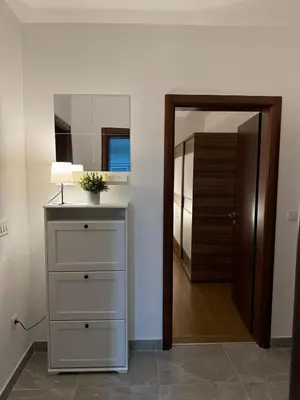 a room with a dresser and a mirror and a door at Azzurro Apartment in Utjeha in Utjeha